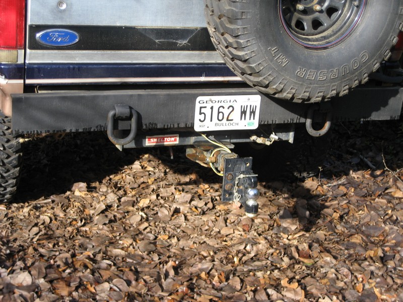 Rear view of a Ford Bronco with a spare tire and trailer hitch.