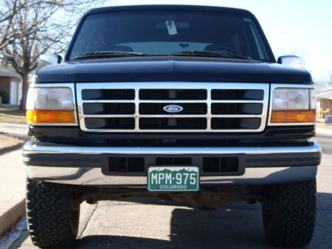 1996 Ford Bronco - Front view of a black Ford Bronco with a chrome grille and bumper. The vehicle has a Colorado license plate that reads "MPM-975".