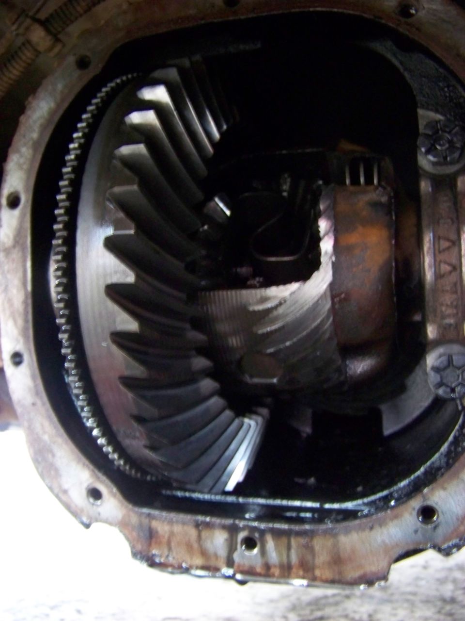 Close-up of differential gears in a vehicle's rear axle.