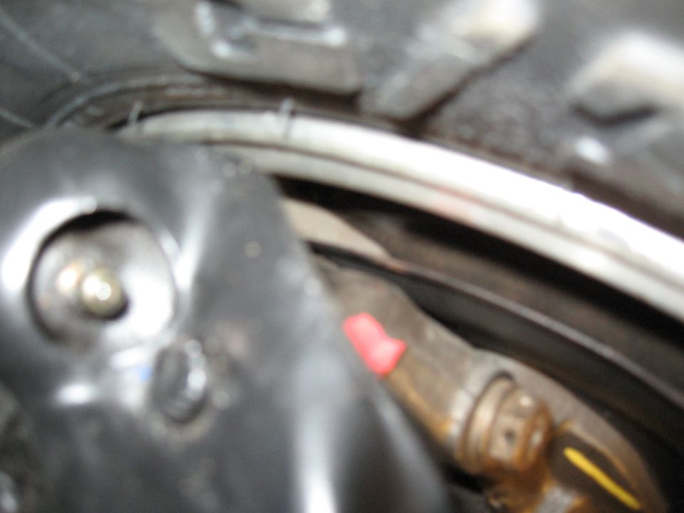 Close-up of engine component with red cap