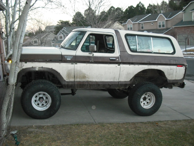 Lifted 1979 Ford Bronco, side view, white and brown two-tone, large off-road tires
