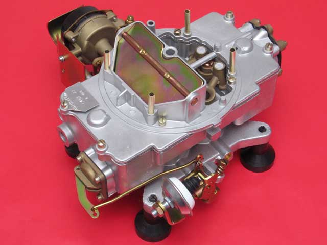Rebuilt four-barrel carburetor on a red background