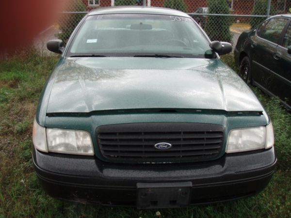 Front view of a dark sedan with a black grille
