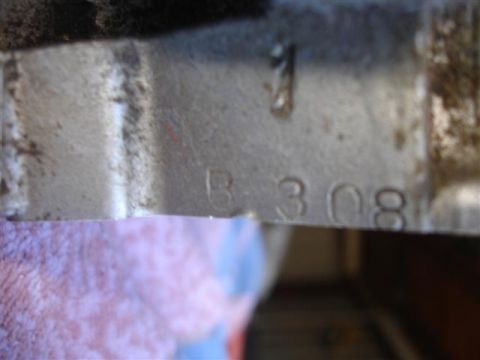 1996 Ford Mustang - Close-up of a metal part showing stamped alphanumeric characters.
