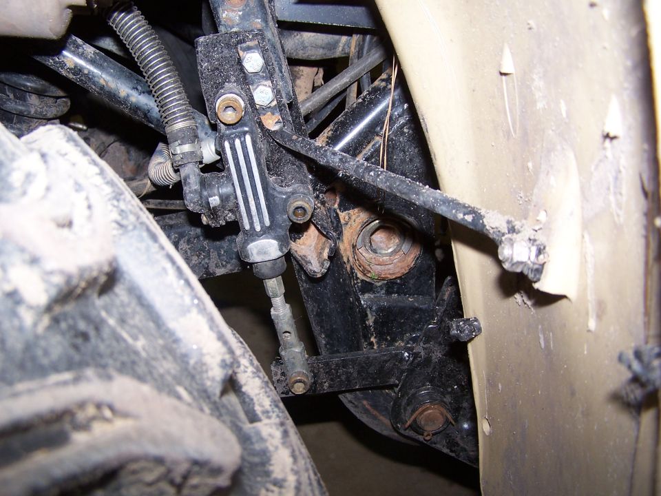 Close-up of engine bay component, possibly a shock absorber or strut