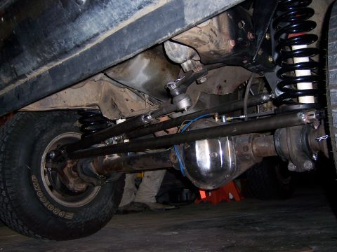 1991 Ford Bronco - Underside view of custom steering and suspension parts, possibly for an off-road vehicle.