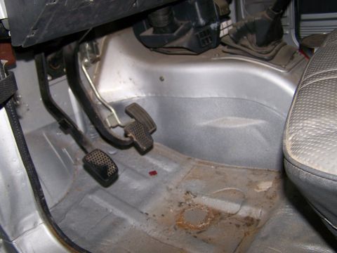 1988 Suzuki Samurai - Interior floor view of a 1988 Suzuki Samurai, showing the pedals and part of the passenger seat.