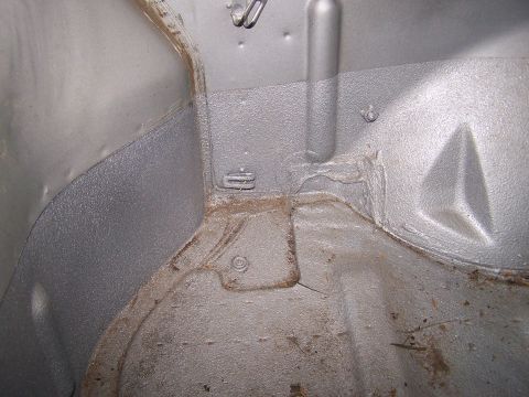 1988 Suzuki Samurai - Close-up view of the textured interior of a vehicle's cargo area, showing seams and mounting points.