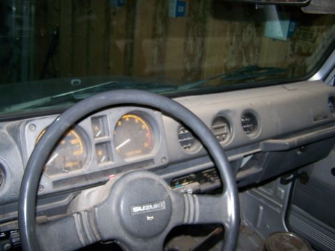 1988 Suzuki Samurai - Interior view of a Suzuki Samurai, showing the dashboard, steering wheel, and instrument cluster.