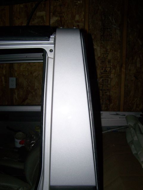 1988 Suzuki Samurai - Close-up view of a vehicle's silver door frame and soft top edge, with a watermark for Supermotors.net.