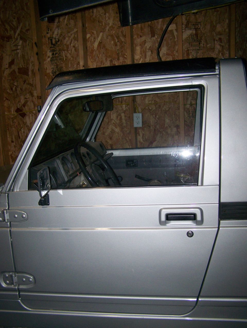 Silver 1988 Suzuki Samurai interior and side door