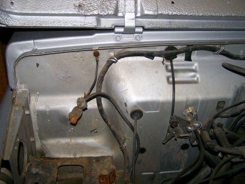 1988 Suzuki Samurai - Wiring harness and various metal parts are visible in the engine compartment.