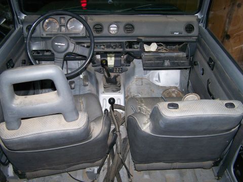 1988 Suzuki Samurai - Interior view of a 1988 Suzuki Samurai, showing the dashboard, steering wheel, and seats.