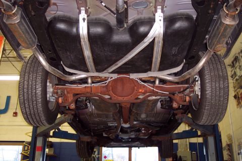 2001 Ford Crown Victoria - Underside view of a car on a lift, revealing the fuel tank and exhaust components.
