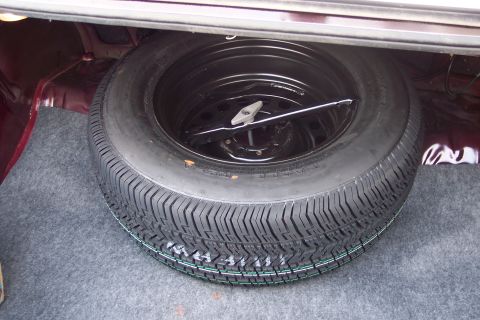 2001 Ford Crown Victoria - Spare tire and jack are visible in the trunk of the vehicle.