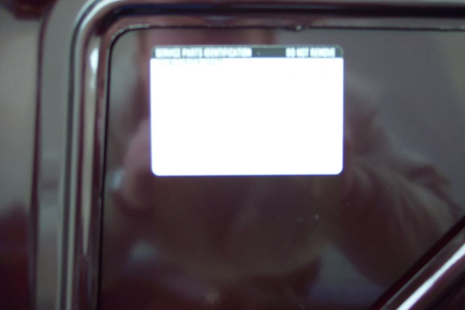 Close-up of a digital display screen with text 'SERVICE PARTS IDENTIFICATION' and 'DO NOT REMOVE'
