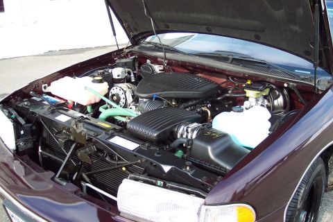 2001 Ford Crown Victoria - The engine bay of a 1996 Chevrolet Caprice is displayed with the hood raised.