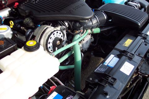 2001 Ford Crown Victoria - The engine bay of a vehicle, showing various components and hoses.