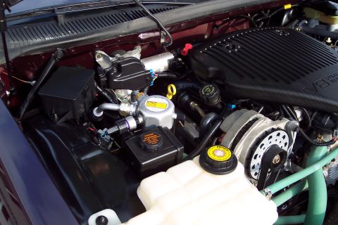 2001 Ford Crown Victoria - The engine bay of a 1996 Chevrolet Caprice is visible, displaying its V8 engine components.