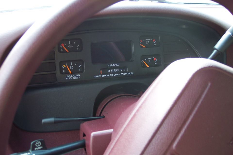 Dashboard gauges and steering wheel. Fuel and temp gauges visible
