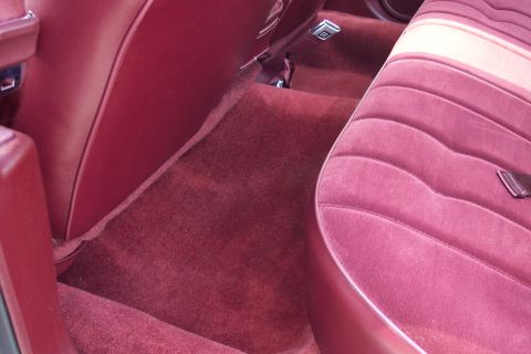2001 Ford Crown Victoria - Interior view of a car's passenger side with maroon velour seats and matching carpet.