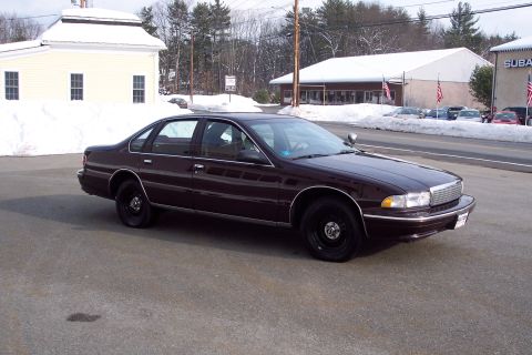 2001 Ford Crown Victoria - This dark red 1996 Chevrolet Caprice sedan is shown in a 3/4 front view, parked in a lot with snow visible.