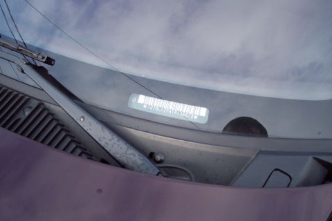 2001 Ford Crown Victoria - VIN sticker on windshield shows barcode and identification number JG7BL52P4TR136678.
