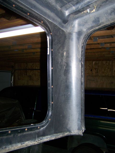 1988 Suzuki Samurai - Interior view of a vehicle's hardtop structure, showing rivets and window frames.