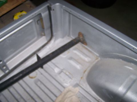 1988 Suzuki Samurai - Interior of a silver truck bed showing structural details and some rust.
