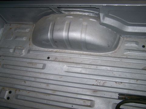 1988 Suzuki Samurai - The ribbed floor and wheel well of a vehicle's cargo area are visible in this shot.