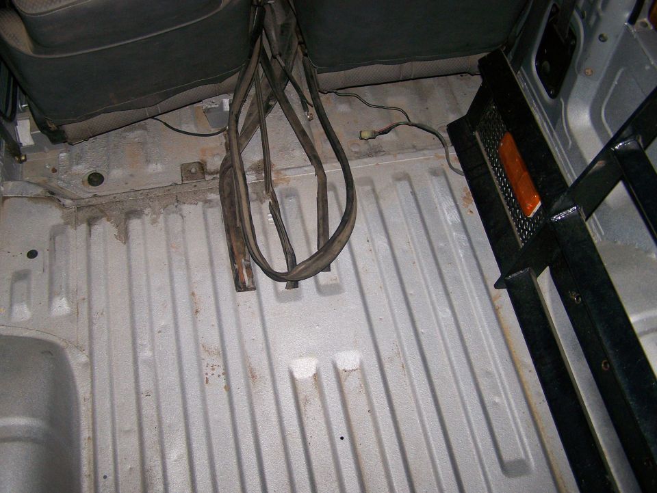 Interior cargo area with ribbed floor and black roll bar