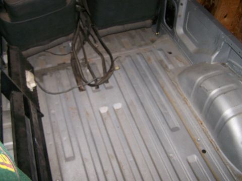 1988 Suzuki Samurai - The interior cargo area shows a ribbed metal floor and exposed wiring harness.