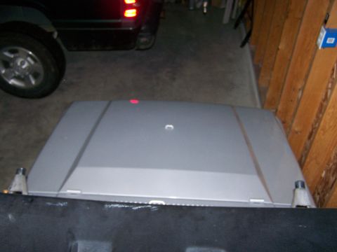 1988 Suzuki Samurai - A gray Suzuki Samurai hood is shown in a garage, with a red marker light on top.