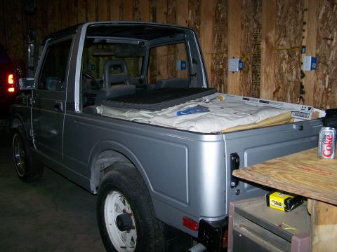 1988 Suzuki Samurai - This 1988 Suzuki Samurai is shown from a three-quarter front angle, with its top removed and interior visible.