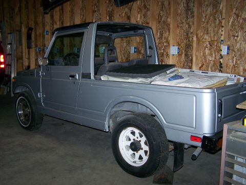 1988 Suzuki Samurai - This 1988 Suzuki Samurai pickup truck is shown in a garage with its top removed.