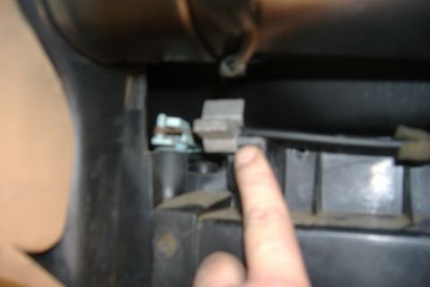 1989 Ford Bronco - A blurry close up of the air flow direction line. Take the clip off (gray thing next to my finger) and then slide the wire up and off.