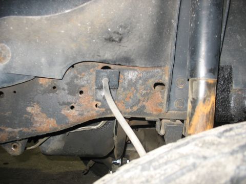 1995 Ford C-350 (Centurion Conversions) - The underside of a vehicle shows significant rust on the frame and suspension components.