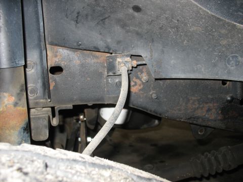 1995 Ford C-350 (Centurion Conversions) - Detail of the undercarriage, showing a brake line attached to the frame.