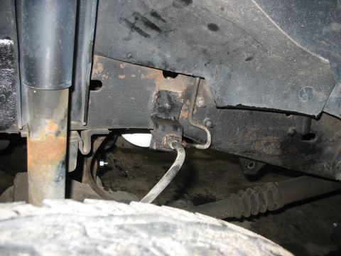 1995 Ford C-350 (Centurion Conversions) - Undercarriage view showing frame, shock, and suspension components of a truck.