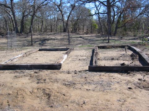 1996 Ford Bronco - Two empty raised garden beds are visible in a rural, wooded landscape.