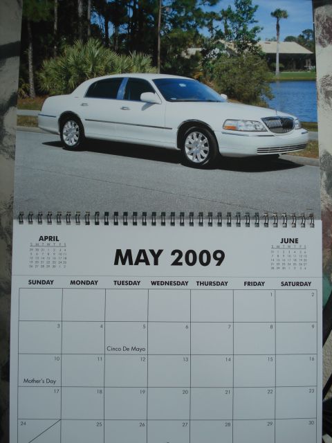 2000 Ford Crown Victoria - A white sedan is pictured on a calendar page for May 2009.