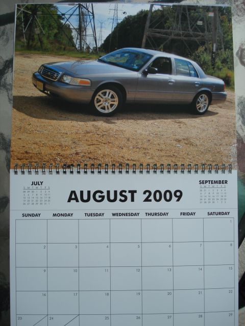 2000 Ford Crown Victoria - A 2000 Ford Crown Victoria is parked outdoors on a dirt lot, with industrial power lines visible.
