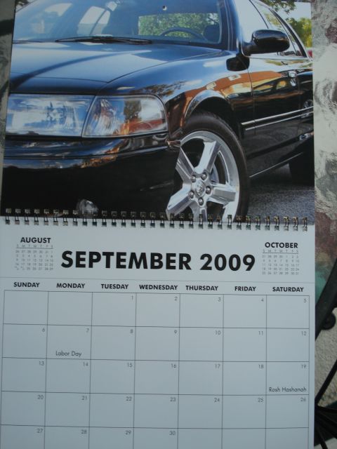 2000 Ford Crown Victoria - A calendar page for September 2009 features a close-up of a black sedan's front quarter panel and wheel.