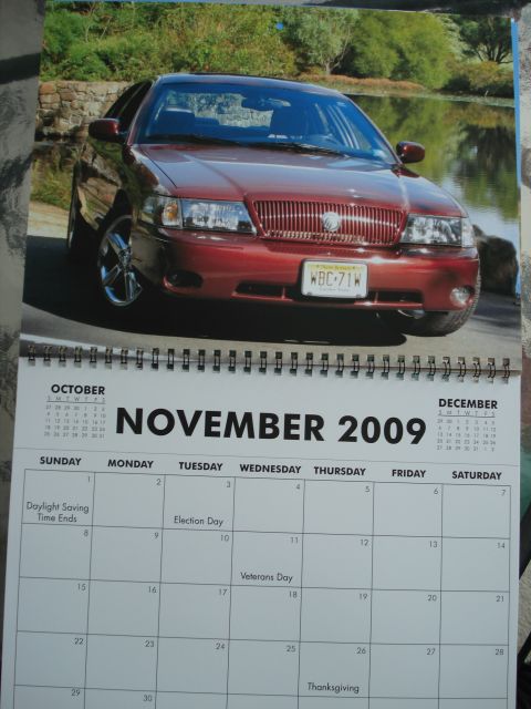 2000 Ford Crown Victoria - A red sedan is pictured on a calendar page for November 2009.
