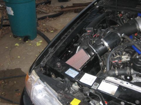1996 Ford Thunderbird - Aftermarket cold air intake system installed in the engine bay of a vehicle.