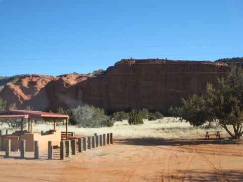 1993 Ford Bronco - Desert landscape with red rock formations, a picnic shelter, and a picnic table under a tree.