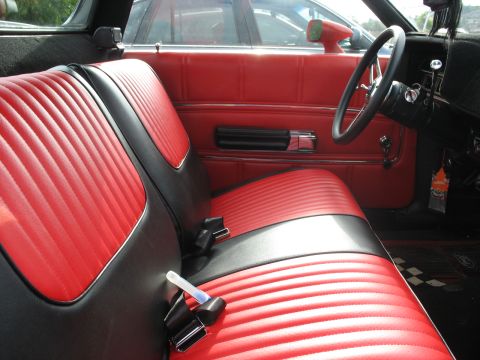 1971 Ford Ranchero - The interior of a 1971 Ford Ranchero features red and black vinyl seats and matching door panels.