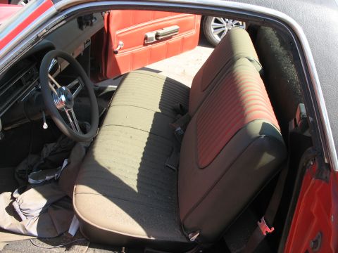 1971 Ford Ranchero - The interior of a 1971 Ford Ranchero features distinctive green and red striped upholstery on the bench seat and red door panels.