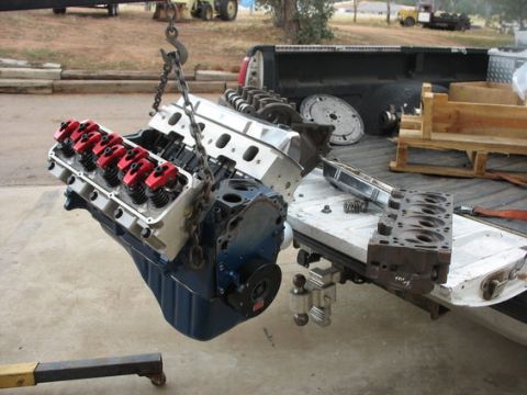 1971 Ford Ranchero - Engine parts being loaded into a truck bed with an engine hoist.