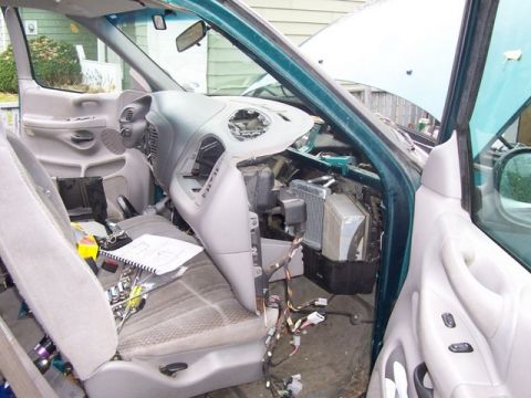 2007 Ford Mustang - The interior of a vehicle is shown with the dashboard removed, revealing the internal components and wiring.